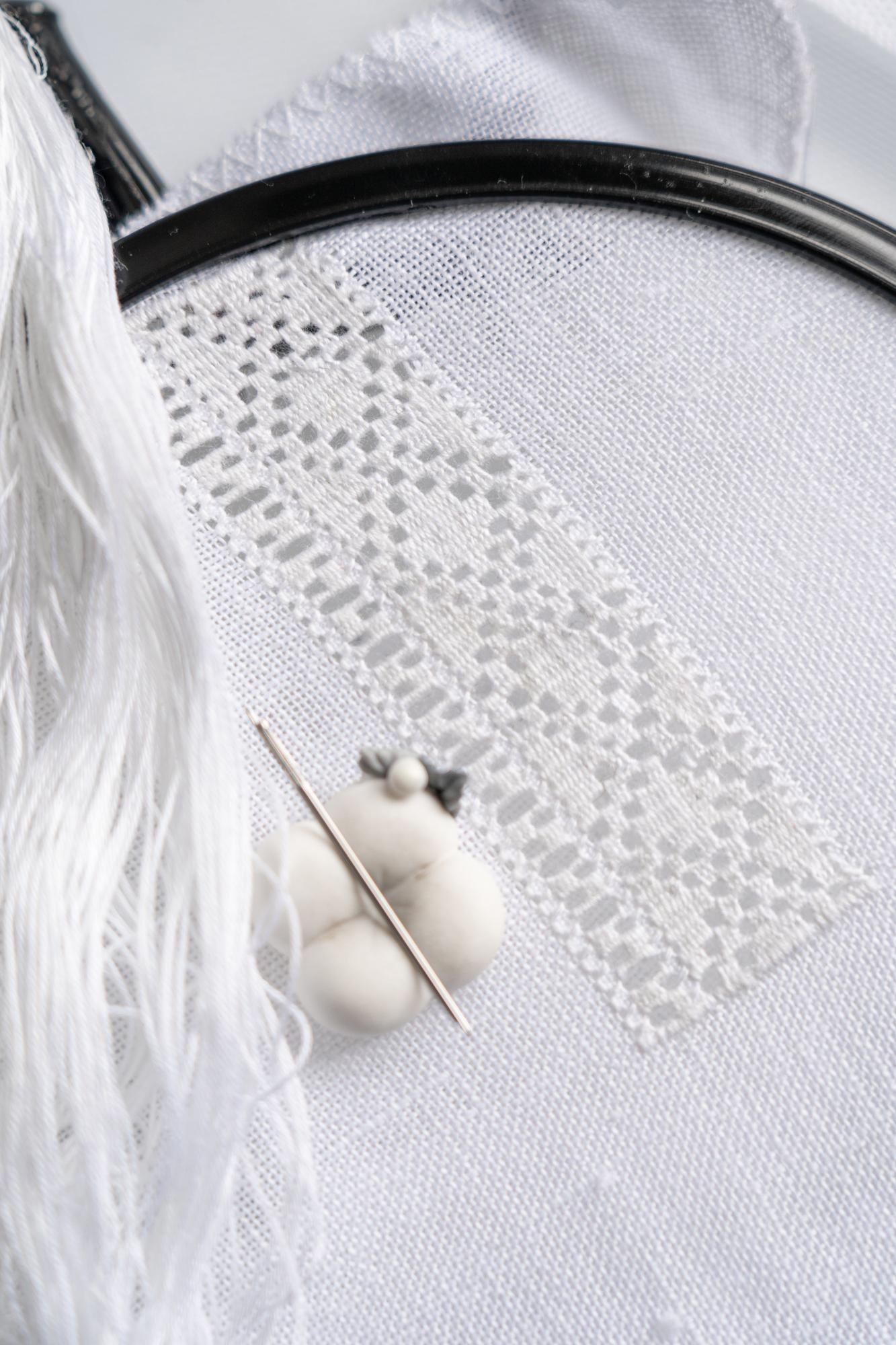 close-up of embroidered floral stitch on linen